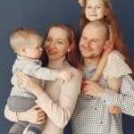 A joyful family portrait showcasing parents and their two children, expressing love and togetherness.